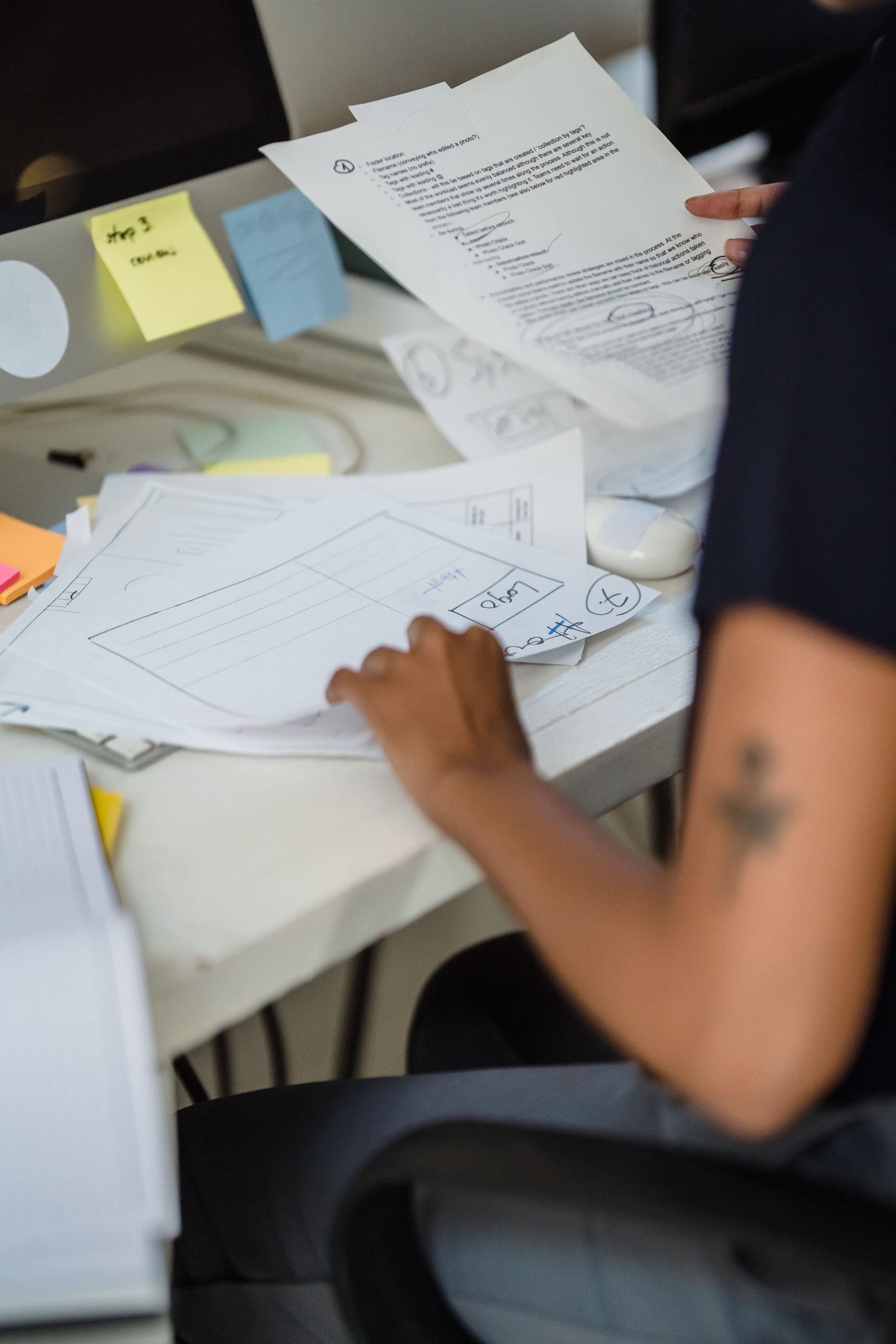 Professional reviewing official paperwork at a desk